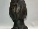 an image of a wooden sculpture of a woman ' s head on a pedestal