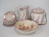 a white table topped with a bowl and a bowl and a pitcher