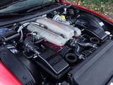 a red car with a engine in it ' s hood