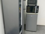 a refrigerator and a microwave in the corner of a room