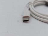 a close up of a white usb cable connected to a computer