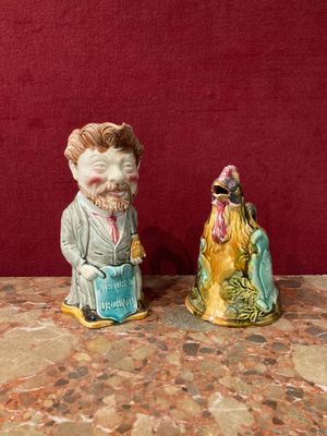 two figurines of a man and a woman sitting on a table