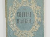 a blue book with gold writing on it on a white surface