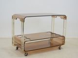 an image of a glass and brass serving cart