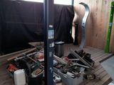 une image d'un garage avec de nombreux outils sur le sol