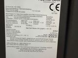 the label on the back of a black refrigerator is clearly visible