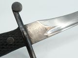 a close up of a knife on a white surface