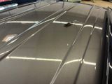a car that has been painted silver in a garage