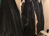 many coats hanging on a rack in a closet