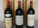 three bottles of wine are lined up in front of a wooden box