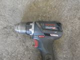 a cordless drill that is laying on the ground