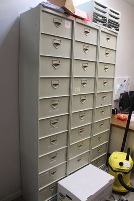 a stack of filing cabinets in the corner of a room