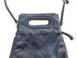 black leather purse with handle and strap on a white background