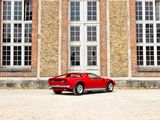 a red sports car parked in front of a large brick building