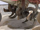 a close up of a tractor with a plow attached to it ' s back