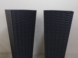 pair of black wicker vases on a white background
