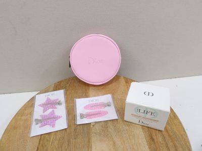 a pink clock sitting on top of a wooden table