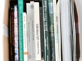 a box full of books sitting on a white surface