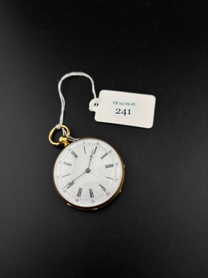 a close up of a pocket watch with a tag on it