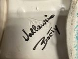 a close up of a white porcelain toilet with a handwritten message on it