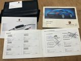 a lot of papers and a picture of a car on the table