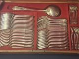 a wooden box with silverware in it on a table