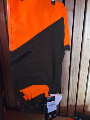 a picture of a pair of gloves and a jacket on a table