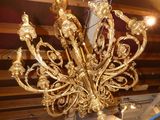 a gold chandelier hanging from the ceiling in a store