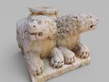a stone sculpture of a sheep and a lamb on a block