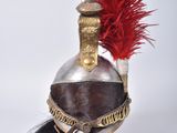 a helmet with a red feather on top of it