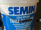 a bucket of cement sitting on top of a blue and white bucket