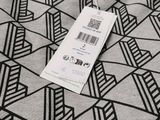 a black and white pattern on a fabric with a price tag attached to it