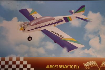 a picture of a toy airplane flying in the sky