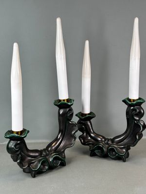 pair of white and green candle holders on a gray surface
