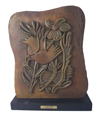 sculpture of a bird on a rock on a wooden base
