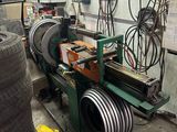 a machine that is working on a tire in a garage