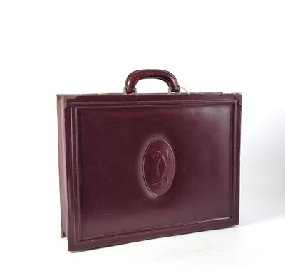 a brown briefcase that is sitting on a white surface