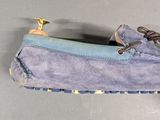 pair of men ' s blue sued driving shoes on a gray surface