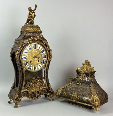 two clocks sitting next to each other on a table