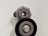 a close up of a pulley and belt on a white surface