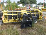 a large yellow machine that is sitting in the grass