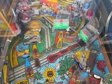 a pinball machine that has a lot of items on it