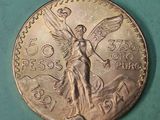 an image of a coin with an angel on it on a green surface