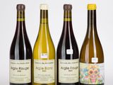 trois bouteilles de vin posées les unes à côté des autres sur une surface blanche