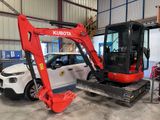 a small excavator that is parked in a garage