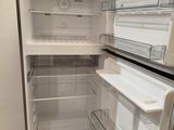 an open refrigerator that is sitting in a room