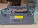 a record player sitting on top of a table in a room