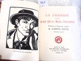 someone is holding a book with a picture of a man in a hat