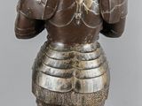 an image of a statue of a man in armor holding a sword