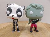 two figurines of a panda bear and a panda bear
